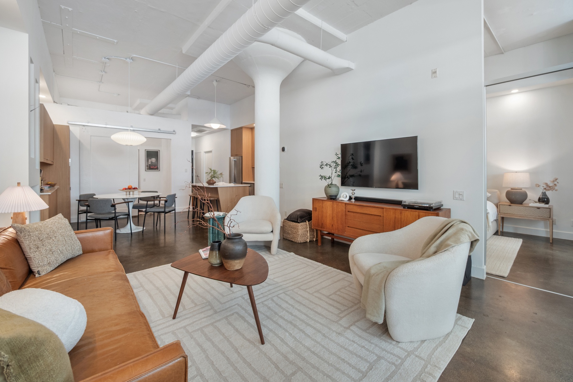 Living room toward kitchen and bedroom