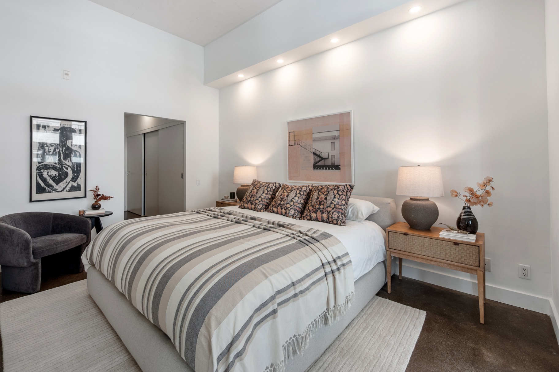 Primary bedroom with king bed and high ceilings