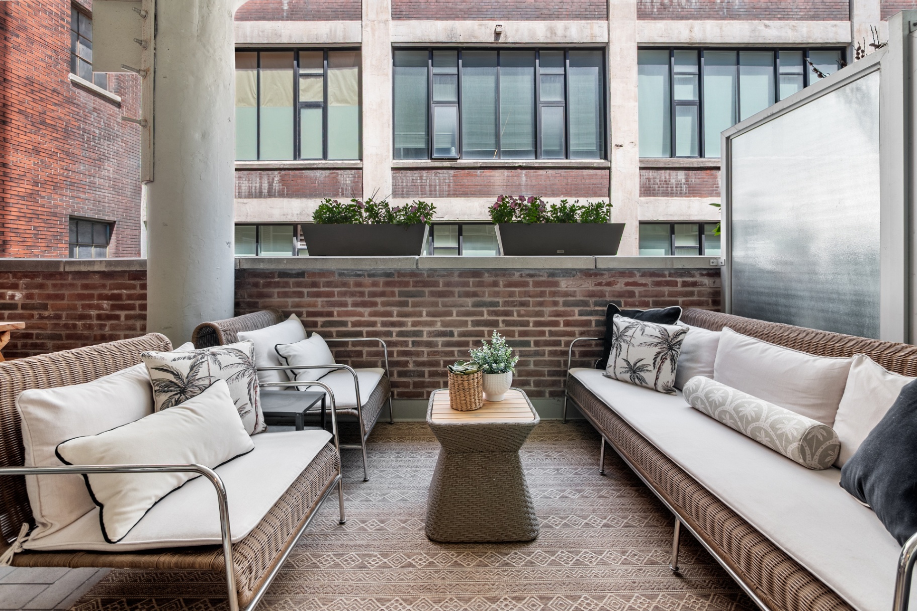 Terrace seating area with sofas and coffee table